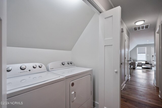 washroom with washing machine and dryer and hardwood / wood-style flooring