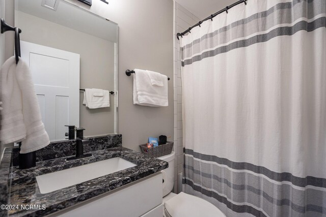 bathroom featuring vanity and toilet