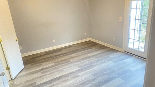 unfurnished room featuring hardwood / wood-style flooring