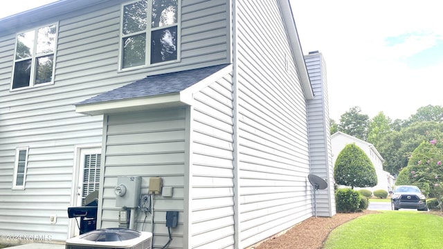 view of side of home with central air condition unit