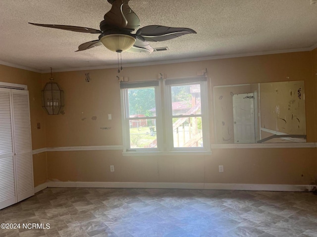 empty room with a textured ceiling, ceiling fan, and ornamental molding