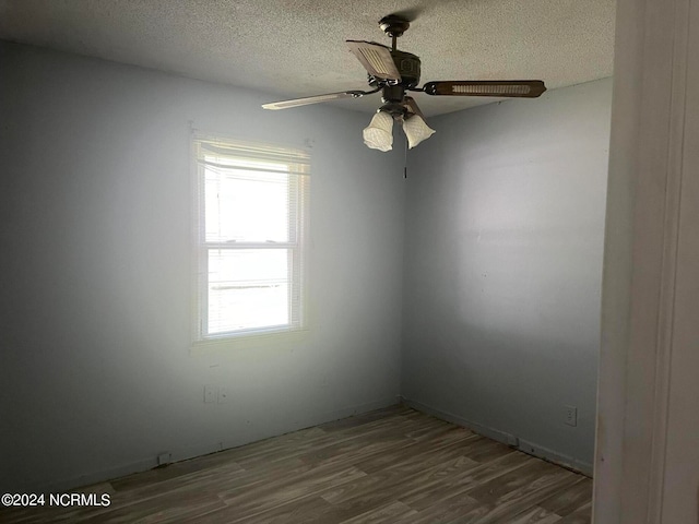 unfurnished room with hardwood / wood-style flooring, a textured ceiling, and ceiling fan