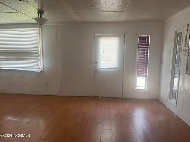 empty room with hardwood / wood-style flooring