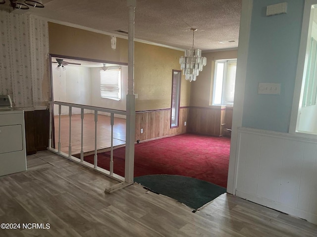 interior space featuring a wealth of natural light, crown molding, washer / clothes dryer, and a textured ceiling