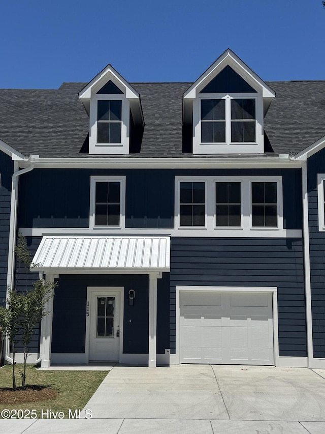 115 Seagate Pl, Wilmington, NC 28403 - view of front of house featuring a garage, concrete driveway, a standing seam roof, roof with shingles, and metal roof