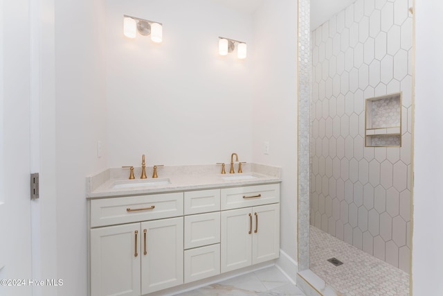 bathroom featuring a tile shower and vanity