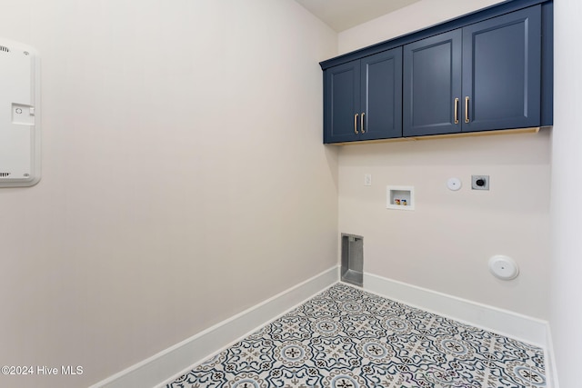 clothes washing area with cabinets, gas dryer hookup, washer hookup, and hookup for an electric dryer