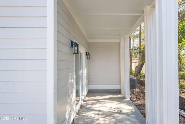 view of exterior entry featuring central AC unit