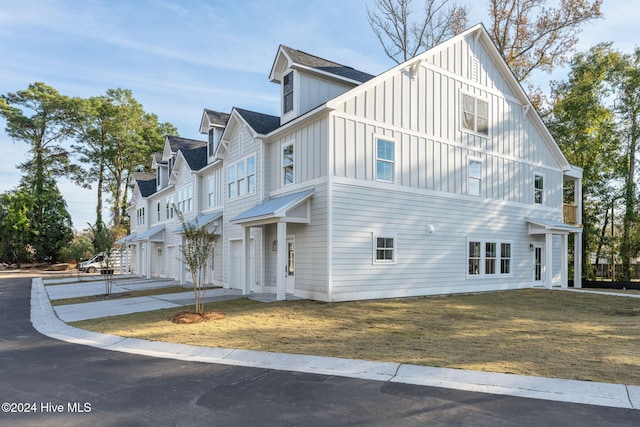 115 Seagate Pl, Wilmington, NC 28403 - view of side of home with board and batten siding, roof with shingles, and a garage