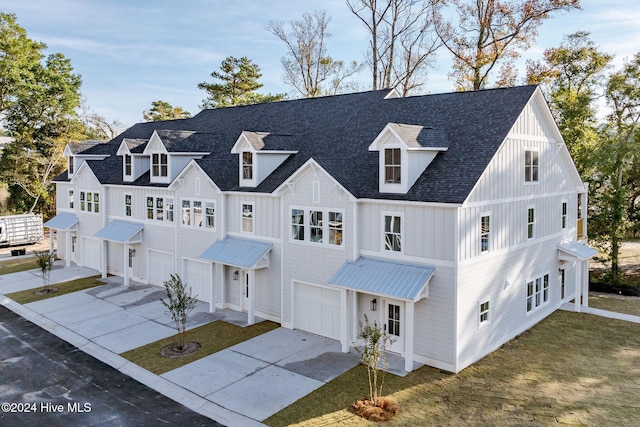 115 Seagate Pl, Wilmington, NC 28403 - modern inspired farmhouse with a garage, driveway, metal roof, a shingled roof, and a front yard