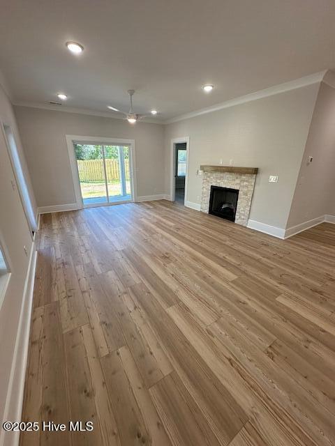 115 Seagate Pl, Wilmington, NC 28403 - unfurnished living room featuring light wood-type flooring, crown molding, a ceiling fan, baseboards, and recessed lighting
