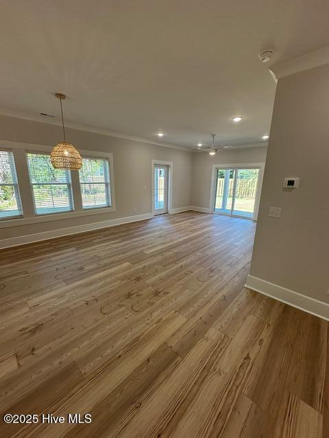 115 Seagate Pl, Wilmington, NC 28403 - unfurnished room with ornamental molding, baseboards, wood finished floors, plenty of natural light, and recessed lighting