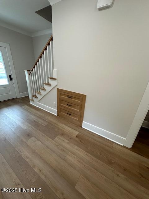115 Seagate Pl, Wilmington, NC 28403 - foyer entrance with crown molding, stairway, wood finished floors, and baseboards