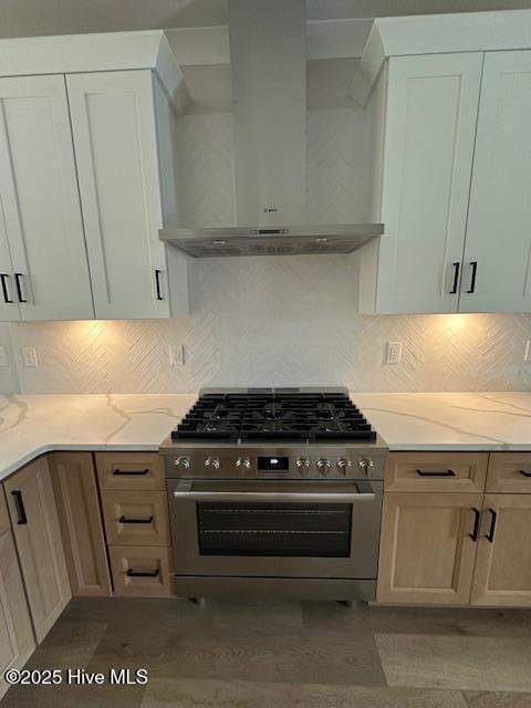 115 Seagate Pl, Wilmington, NC 28403 - kitchen with wall chimney exhaust hood, stainless steel range, light stone counters, and decorative backsplash
