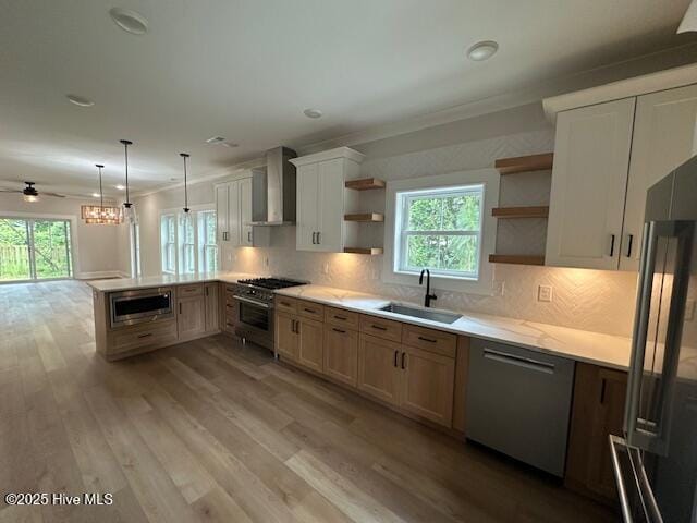 115 Seagate Pl, Wilmington, NC 28403 - kitchen with a sink, open shelves, appliances with stainless steel finishes, wall chimney exhaust hood, and healthy amount of natural light