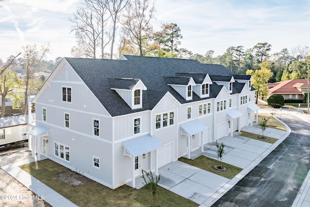 115 Seagate Pl, Wilmington, NC 28403 - rear view of house with a garage, driveway, and roof with shingles