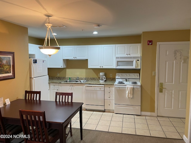 kitchen with light tile patterned flooring, white appliances, white cabinets, decorative light fixtures, and sink