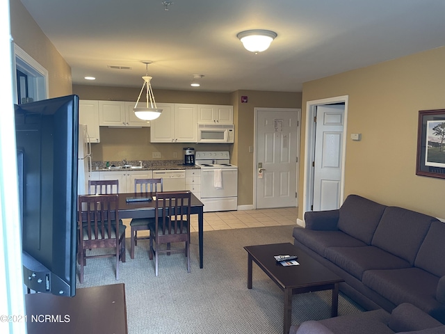 living area with visible vents, baseboards, and light tile patterned floors