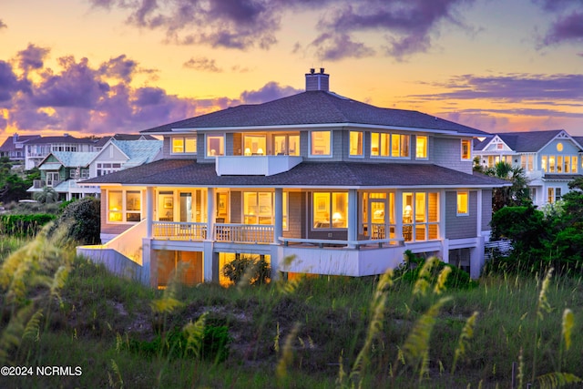 view of back house at dusk