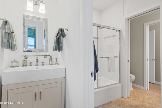 full bathroom with vanity, tile patterned floors, enclosed tub / shower combo, and toilet