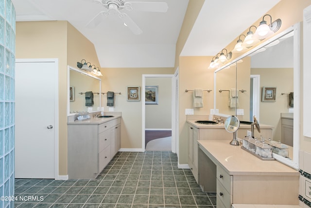 bathroom with tile patterned floors, ceiling fan, vaulted ceiling, and double vanity