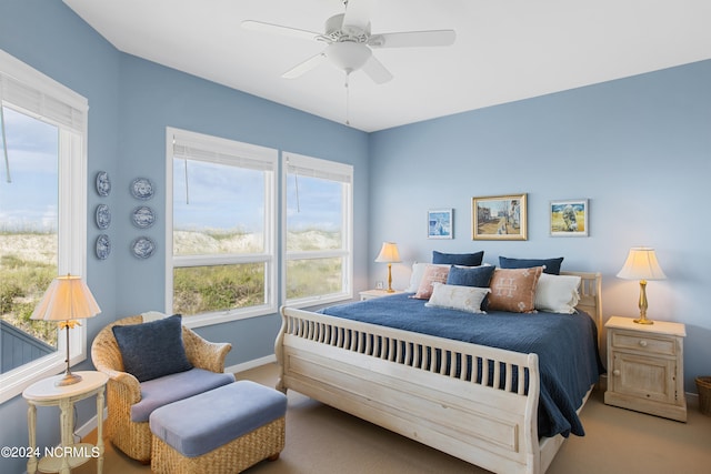 bedroom featuring light colored carpet and ceiling fan