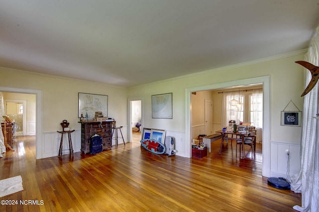 264 Main St, Swanquarter, NC 27885 - living room with hardwood / wood-style flooring, crown molding, and a wainscoted wall