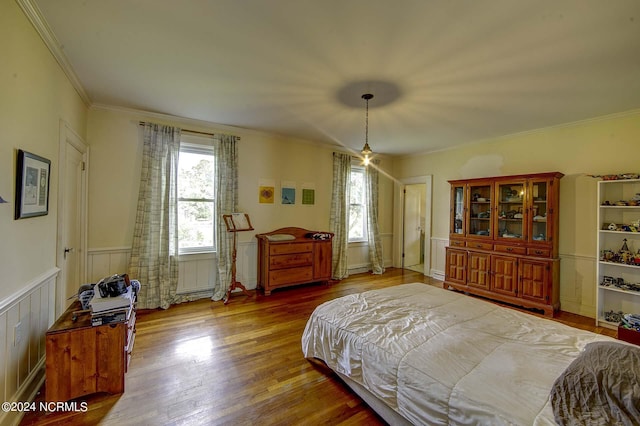 bedroom featuring multiple windows, wood-type flooring, and ornamental molding