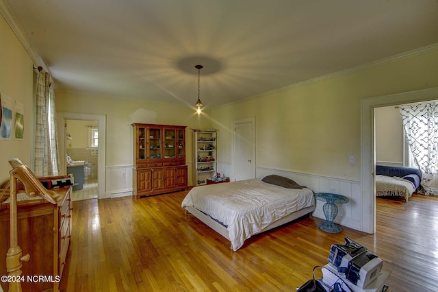 bedroom featuring hardwood / wood-style floors and crown molding