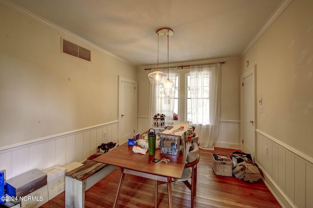 264 Main St, Swanquarter, NC 27885 - dining space with visible vents, crown molding, a wainscoted wall, and wood finished floors
