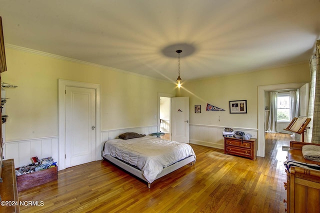 bedroom featuring hardwood / wood-style flooring and crown molding