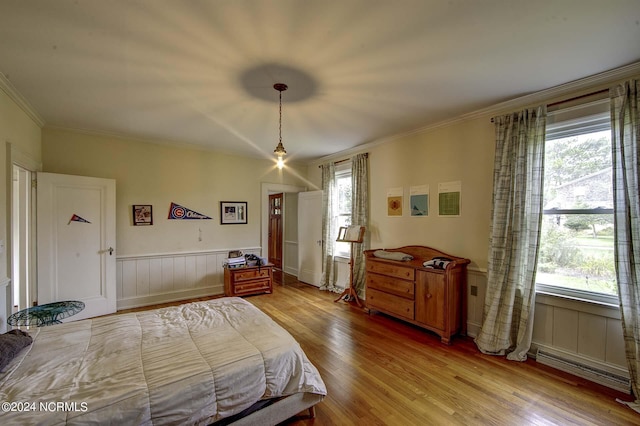 bedroom featuring multiple windows, crown molding, and light hardwood / wood-style floors