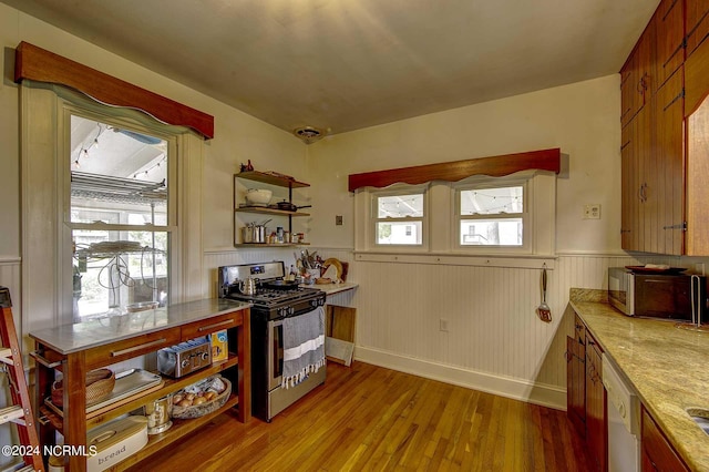 264 Main St, Swanquarter, NC 27885 - kitchen featuring light countertops, a wealth of natural light, wainscoting, stainless steel appliances, and light wood-style flooring