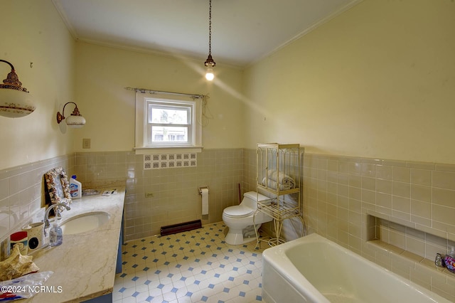 bathroom with tile walls, a tub to relax in, vanity, toilet, and crown molding