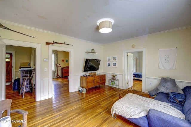 living room featuring wood-type flooring and ornamental molding