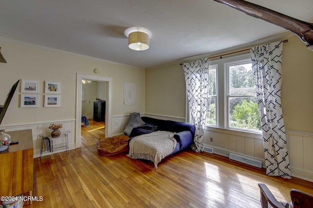 bedroom featuring hardwood / wood-style flooring and crown molding