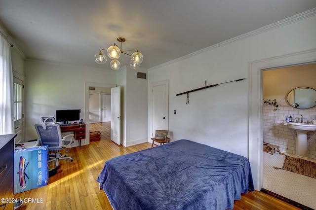 bedroom featuring ornamental molding, wood-type flooring, and a chandelier