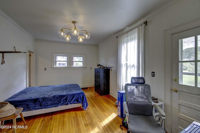 bedroom featuring ornamental molding, hardwood / wood-style floors, and a chandelier