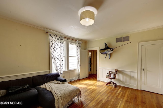 264 Main St, Swanquarter, NC 27885 - bedroom with light wood finished floors, visible vents, ornamental molding, and wainscoting