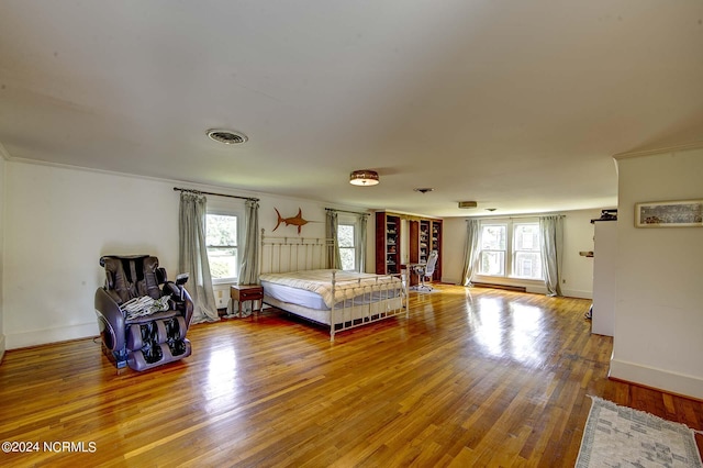 unfurnished bedroom with hardwood / wood-style flooring and ornamental molding