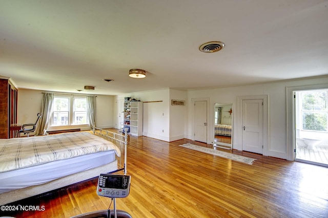 bedroom featuring hardwood / wood-style floors and multiple windows