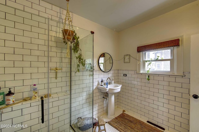 264 Main St, Swanquarter, NC 27885 - bathroom with tile patterned floors, a wainscoted wall, tile walls, and a stall shower