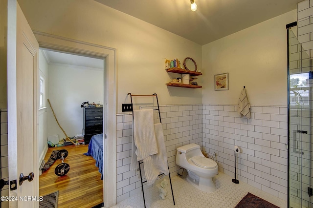 264 Main St, Swanquarter, NC 27885 - bathroom with tile patterned flooring, a wainscoted wall, tile walls, and toilet