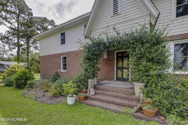 264 Main St, Swanquarter, NC 27885 - exterior space featuring a yard and brick siding