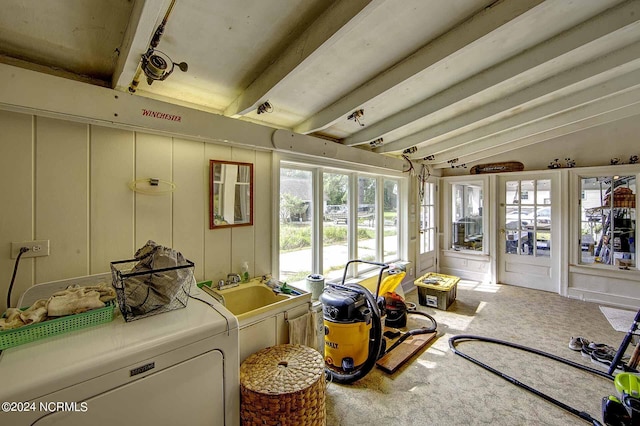 interior space featuring carpet flooring, washer / clothes dryer, and sink