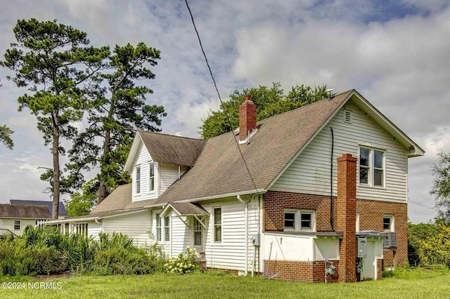 264 Main St, Swanquarter, NC 27885 - back of property with a yard, roof with shingles, and a chimney