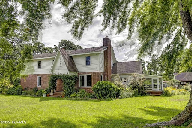 264 Main St, Swanquarter, NC 27885 - back of property with brick siding, a lawn, and a chimney