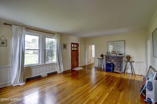 entrance foyer with hardwood / wood-style flooring and crown molding