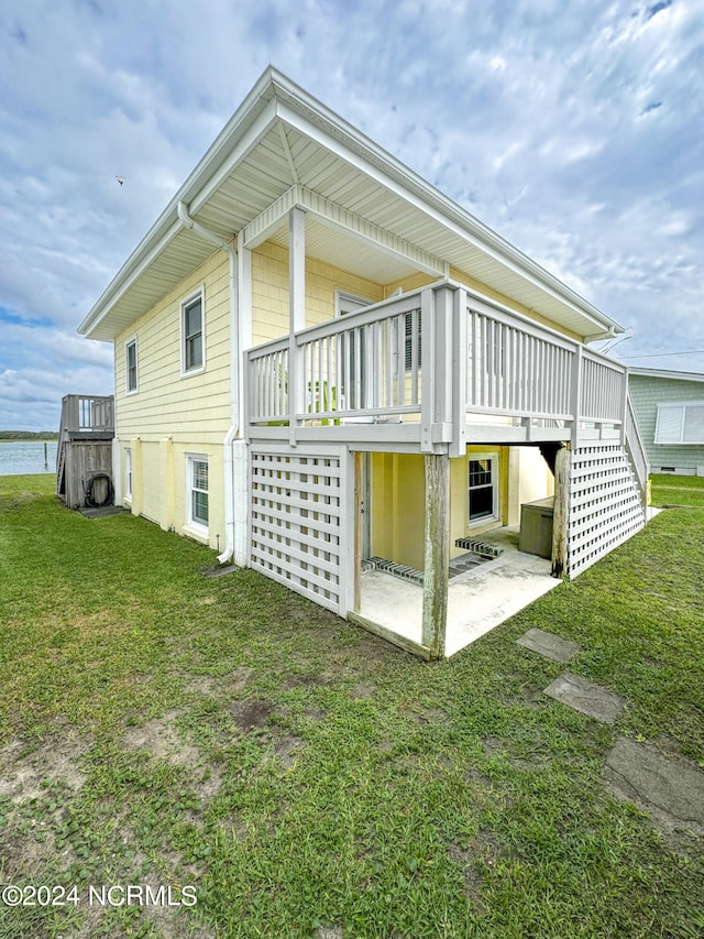 rear view of property with a garage and a yard