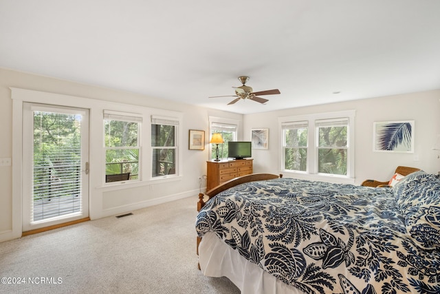 bedroom featuring light carpet, access to exterior, and ceiling fan